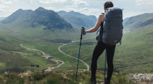 Man on hill in walking gear looking at view